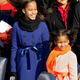 Malia and Sasha Obama stand on the stage ahead of the inauguration of Barack Obama as the 44th President of the United States of America on the West Front of the Capitol January 20, 2009 in Washington, DC.